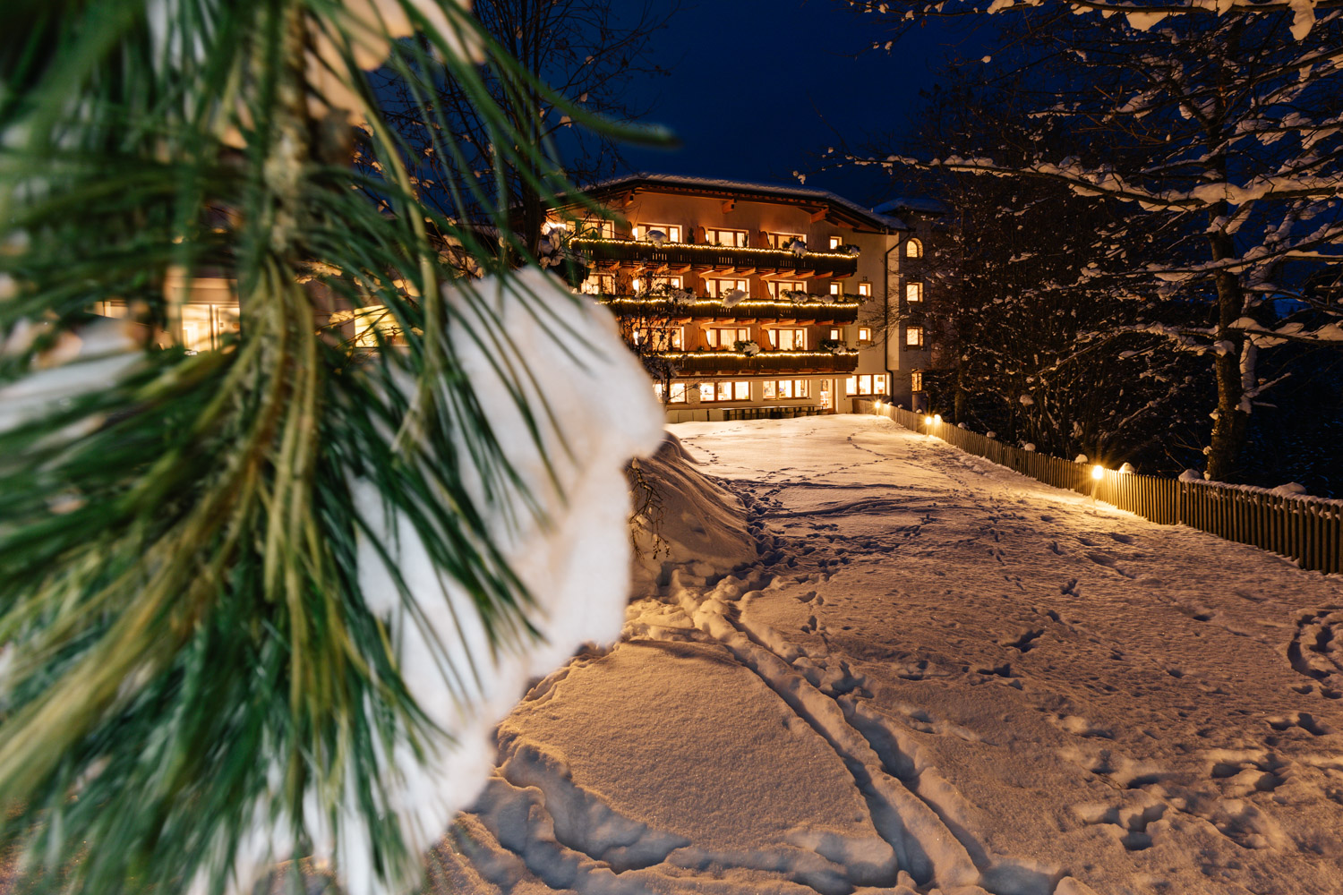 Ganis Resort illuminated on a snowy winter evening in the Dolomites