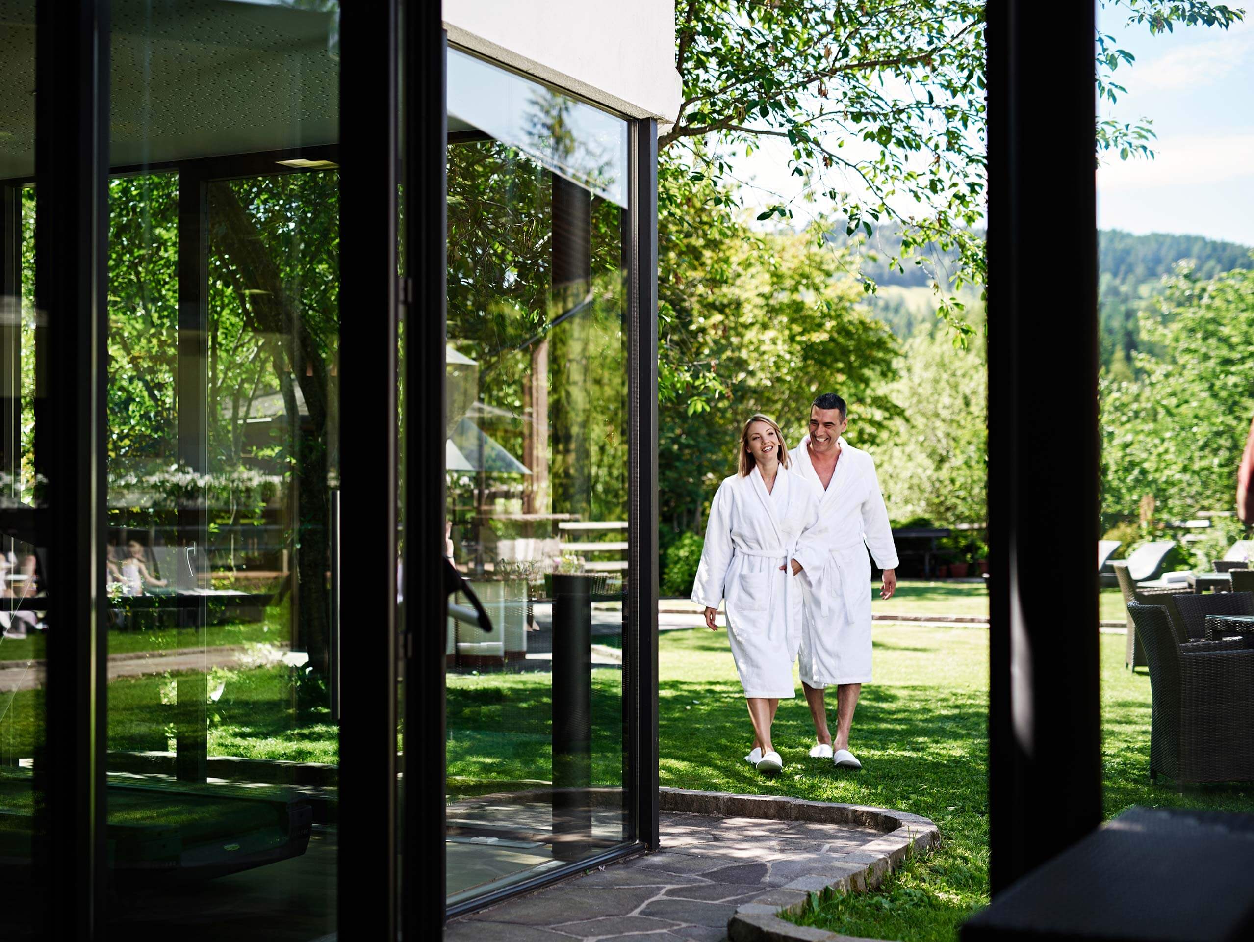 Couple in robes walking outdoors at the Ganis Resort Dolomites